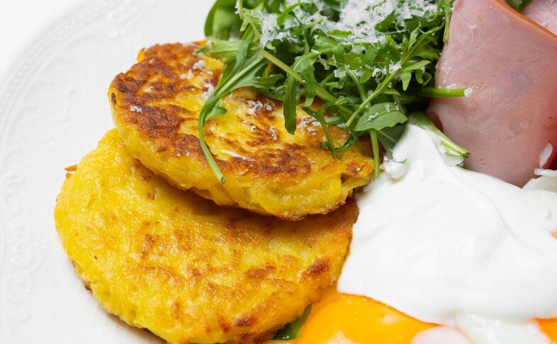 Картофельные драники с глазуньей, мортаделлой, миксом зелени и сметаной